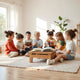 Children reading an open picture book on a table in a bright living room