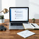 Minimal workspace with laptop and notes illustrating structured AI prompting