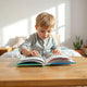 Child flipping through a colorful interactive storybook with raised pages at a bright table
