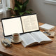 Printed story booklet and generic PDF pages on a desk with reading glasses and warm natural light