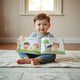 Child reading an open interactive children’s book with lift-the-flap elements and colorful illustrations