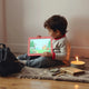 Child reading an adventure e-book on a tablet with a compass and map nearby