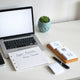 Minimal workspace with a laptop prompt area and handwritten placeholder notes for structuring AI requests