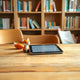 A friendly fox figurine and open e-book tablet on a cozy kids library table