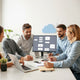 Team reviewing AI automation workflow diagrams on a laptop at a modern desk