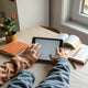 Parent and child using a tablet to read a storybook on a cozy desk