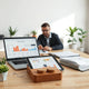 Project manager reviewing delivery dashboard on a laptop with workflow timeline graphics