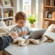 Child reading an early reader story on a tablet at a cozy table with a parent nearby